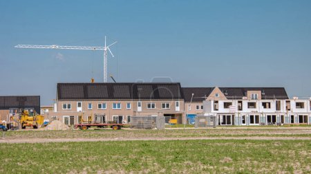 Photo for Newly build houses with solar panels attached on the roof against a sunny sky, new buildings with black solar panels. - Royalty Free Image