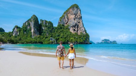 Photo for Railay Beach Krabi Thailand, the tropical beach of Railay Krabi, a couple of men and women on the beach, Panoramic view of idyllic Railay Beach in Thailand with a traditional long boat. - Royalty Free Image