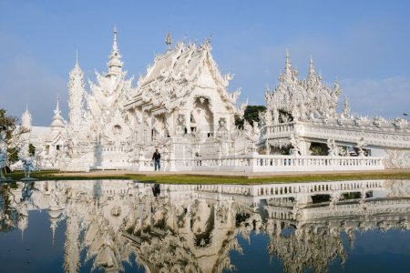 Photo for White temple Chiang Rai Thailand, Wat Rong Khun, aka The White Temple, in Chiang Rai, Thailand with a blue sky and reflection in the lake - Royalty Free Image
