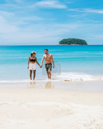 Foto de Couple walking on the beach of Kata Phuket Thailand during vacation - Imagen libre de derechos