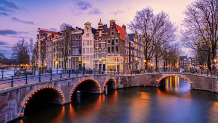 Photo for Amsterdam at night with dancing colorful houses at the Amsterdam canals in the Netherlands. - Royalty Free Image