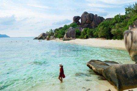 Téléchargez les photos : Young woman at Anse Source dArgent beach La Digue Seychelles Islands, white tropical beach with granite boulders. - en image libre de droit