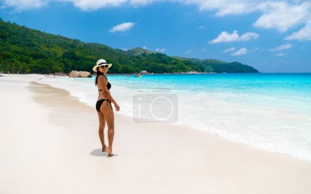 Photo for Young Asian woman at a white tropical beach Anse Lazio beach Praslin Tropical Seychelles Islands. - Royalty Free Image