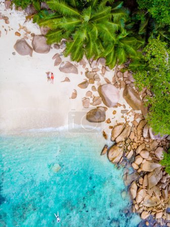 Photo for Drone view from above at Anse Lazio beach Praslin Island Seychelles. a couple of men and women on the beach - Royalty Free Image
