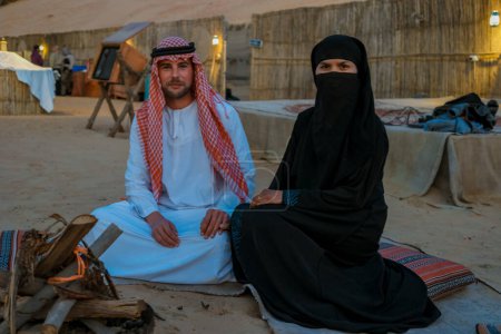 Photo for Couple Arabic clothes during Dubai desert safari at the safari camp, Dubai United Arab Emirates - Royalty Free Image