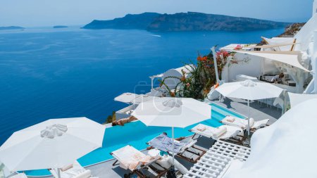 Photo for Vacation at Santorini swimming pool looking out over the Caldera ocean of Santorini, Oia Greece, Greek Island Aegean Cyclades September 2017 - Royalty Free Image
