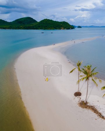 Photo for A couple of men and women walking on the beach at the Island Koh Yao Yai Thailand, a beach with white sand and palm trees on a tropical Island in Thailand Laem had beach - Royalty Free Image