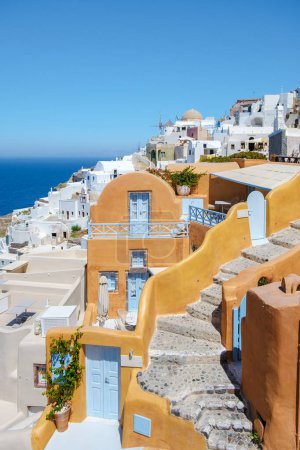 Photo for White churches and blue domes by the ocean of Oia Santorini Greece, a traditional Greek village in Santorini in the evening light - Royalty Free Image