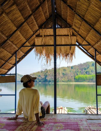 Téléchargez les photos : Les femmes asiatiques visitent le lac Huai Krathing dans le nord-est de la Thaïlande Isaan région célèbre pour ses radeaux de bambou flottants où vous pouvez déjeuner ou dîner au milieu du lac. - en image libre de droit