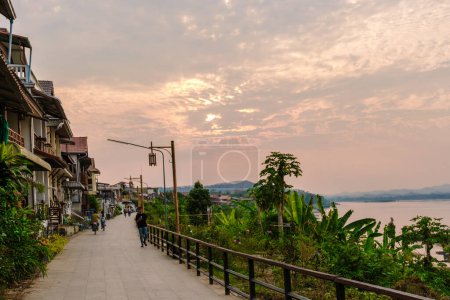 Photo for Chiang Khan village North Eastern Thailand February 2023 a traditional village alongside the Mekong river with wooden house at sunset - Royalty Free Image