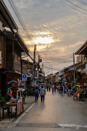 Photo for Chiang Khan village North Eastern Thailand February 2023 , A traditional village with wooden house in the evening at the walking street market of Chiang Khan - Royalty Free Image