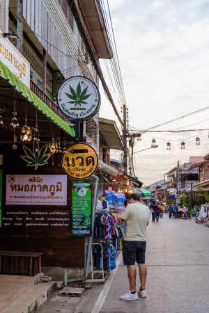 Photo for Chiang Khan village North Eastern Thailand February 2023, tourist outside a cannabis Marijuana shop in the village of Chiang Khan - Royalty Free Image