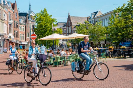 Photo for Leeuwarden Netherlands May 2018, Bright summer day at the canals of the old historical town with people on bicycles in the city. - Royalty Free Image