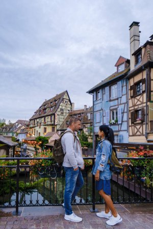 Photo for Colmar, Alsace, France. Petite Venice, men, and women visit the traditional half timbered houses. Colmar charming town in Alsace, France. Beautiful view of colorful romantic city Colmar - Royalty Free Image