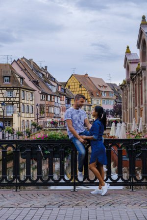 Photo for Colmar, Alsace, France. Petite Venice, men, and women visit the traditional half timbered houses. Colmar charming town in Alsace, France. Beautiful view of colorful romantic city Colmar - Royalty Free Image