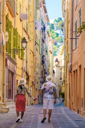 Photo for Menton France, couple men and woman on vacation at the Cote d Azur France, View on the old part of Menton, Provence-Alpes-Cote dAzur, France Europe during summer - Royalty Free Image