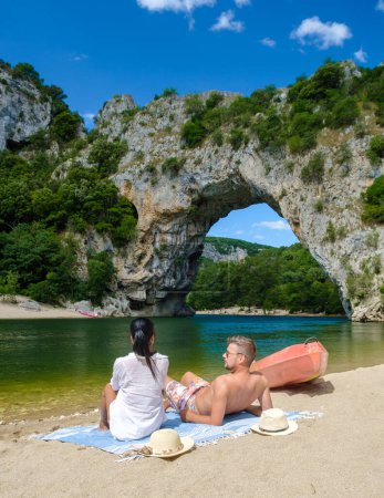 Photo for Couple on vacation in the Ardeche France Pont d Arc, Ardeche France, view of Natural arch in Vallon Pont dArc in Ardeche canyon in France Europe Rhone Alps Dordogne - Royalty Free Image