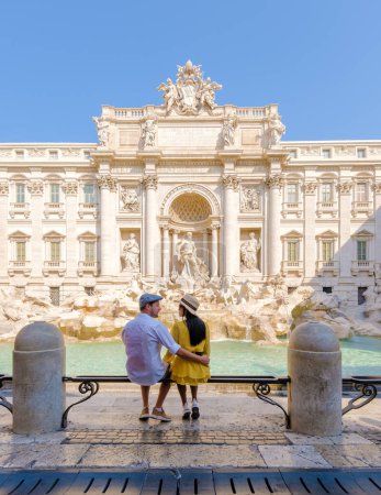 Photo for Men and women tourists at the Trevi Fountain, Rome, Italy. City trip Rome couple on a city trip in Rome during summer vacation - Royalty Free Image