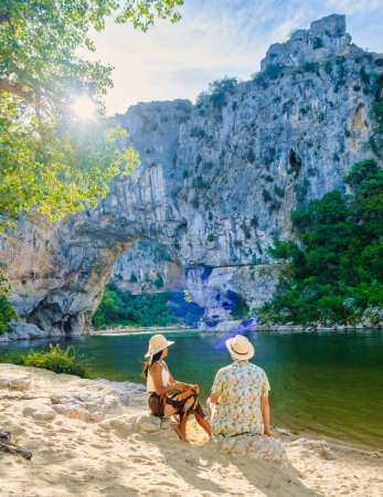 Photo for Couple on vacation in the Ardeche France Pont d Arc, Ardeche France, view of Natural arch in Vallon Pont dArc in Ardeche canyon in France Europe Rhone Alps Dordogne - Royalty Free Image