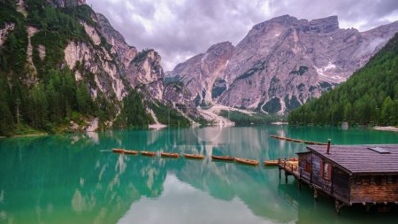 Photo for Boats on the Braies Lake Pragser Wildsee in Dolomites mountains, Sudtirol, Italy. Alps nature landscape - Royalty Free Image