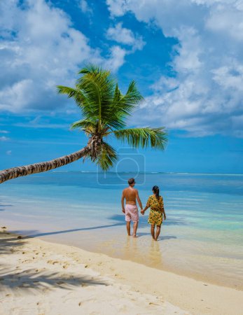 Photo for Mahe Seychelles, a tropical beach with palm trees, and a blue ocean at Mahe Seychelles. Anse Royale beach, couple man and woman on vacation Seychelles - Royalty Free Image