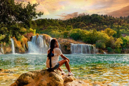 Photo for KRK waterfalls, woman watching sunset at the waterfall Croatia Krk national park Croatia - Royalty Free Image