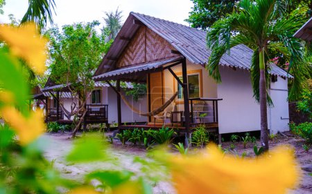 Photo for Bamboo hut bungalows on the beach in Thailand. simple backpacker accommodation in Thailand on the beach in a garden - Royalty Free Image