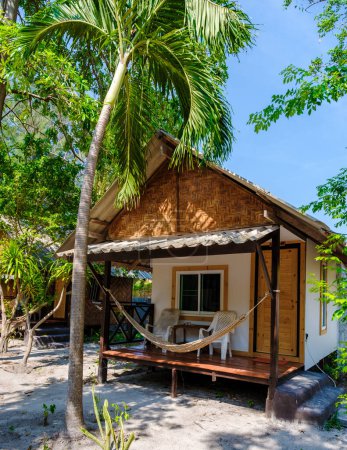 Photo for Bamboo hut bungalows on the beach in Thailand. simple backpacker accommodation in Thailand on the beach in a garden - Royalty Free Image