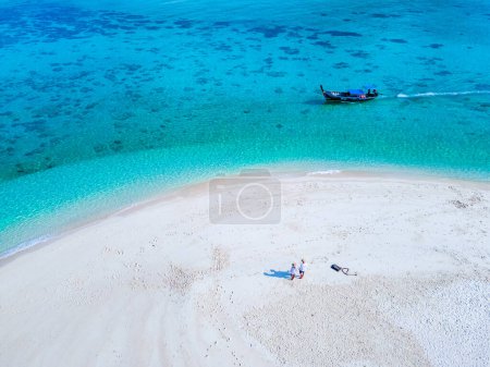 Photo for Couple of men and women on the beach of Ko Lipe Island Thailand. drone aerial view of a sandbank in the ocean - Royalty Free Image
