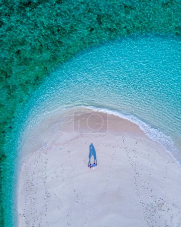 Photo for Couple of men and women on the beach of Ko Lipe Island Thailand. drone aerial view of a sandbank in the ocean on a sunny day - Royalty Free Image