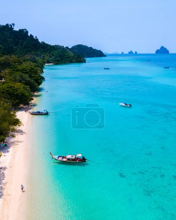Photo for Drone view at the beach of Koh Kradan island in Thailand, aerial view over Koh Kradan Island Trang with longtail boats in the ocean on a sunny day - Royalty Free Image