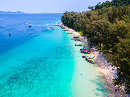Photo for Drone view at the beach of Koh Kradan island in Thailand, aerial view over Koh Kradan Island Trang with longtail boats in the ocean - Royalty Free Image