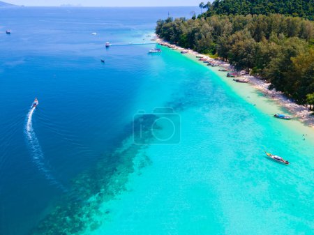 Photo for Drone view at the beach of Koh Kradan island in Thailand, aerial view over Koh Kradan Island Trang with longtail boats in the ocean on a sunny day - Royalty Free Image
