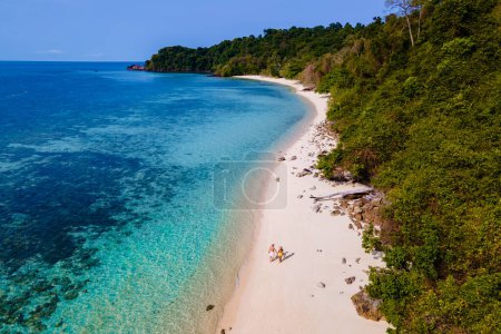 Photo for Drone view at the beach of Koh Kradan island in Thailand, aerial view over Koh Kradan Island Trang, couple of men and women on the beach during vacation in Thailand - Royalty Free Image
