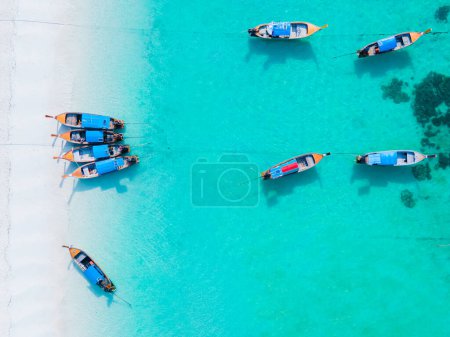 Photo for Colorful Longtail boats in the blue ocean of Koh Lipe Island Southern Thailand with turqouse colored ocean and white sandy beach at Ko Lipe. - Royalty Free Image