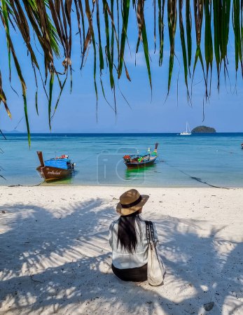 Photo for Koh Lipe Island Southern Thailand with turqouse colored ocean and white sandy beach at Ko Lipe. a women on vacation in Thailand walking at the beach - Royalty Free Image