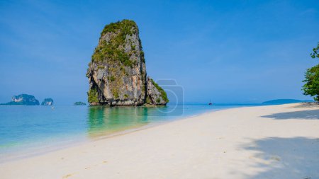 Photo for Railay Beach Krabi Thailand, the tropical beach of Railay Krabi, Panoramic view of idyllic Railay Beach in Thailand with a traditional long boat and a cloudy sky - Royalty Free Image