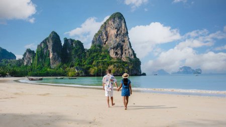 Photo for Men and women relaxing on the beach during a vacation in Thailand Railay Beach Krabi. - Royalty Free Image
