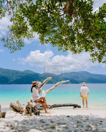 Photo for Ko Ra Wi Island Southern Thailand, tropical white sandy beach with turqouse colored ocean at Tarutao National Park, Koh Rawi, Tambon Ko Tarutao, couple of men and women on vacation in Thailand - Royalty Free Image