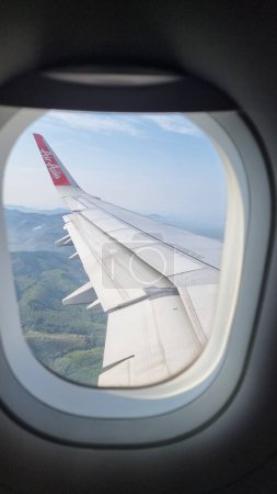 Photo for Bangkok Thailand April 2023, view from an airplane window at an Airasia airplane during a flight from Bangkok to Hat Yai - Royalty Free Image