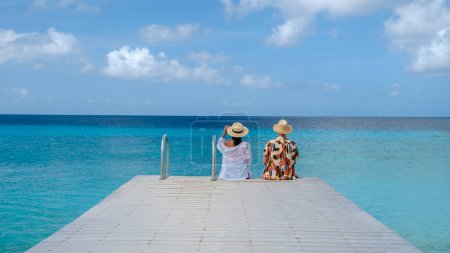 Playa Porto Marie Beach in Curacao, a Couple of men and woman on a tropical beach on the Caribbean Island of Curacao. 