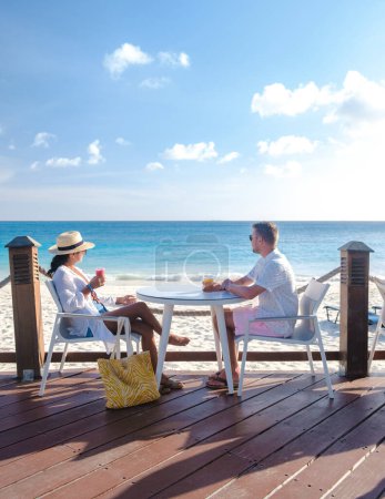 Foto de Resort de lujo con piscina cerca de Palm Beach Aruba Caribbean, pareja de hombres y mujeres de mediana edad en vacaciones de lujo en el Caribe durante el verano - Imagen libre de derechos