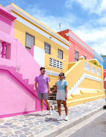 Téléchargez les photos : Bo Kaap Canton de rue coloré au Cap, est une rue colorée avec des maisons en Afrique du Sud. Bo Kaap ou ancien quartier de Malay Quarter, quelques hommes et femmes en voyage au Cap - en image libre de droit