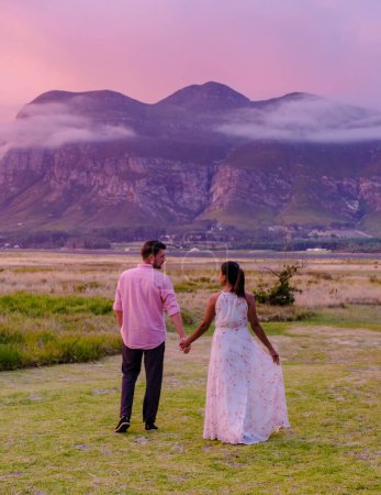 Photo for Mountains and grassland near Hermanus at the Garden Route Western Cape South Africa Whale coast. A couple man and woman mid age in front of their lodge during a vacation in South Africa - Royalty Free Image