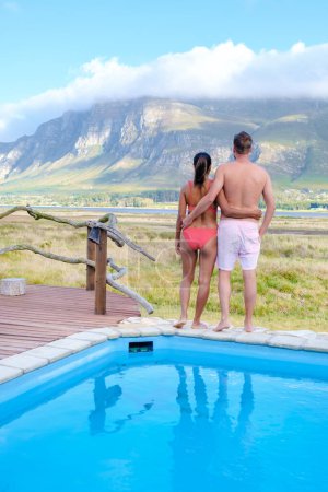 Photo for Mountains and grassland near Hermanus at the Garden Route Western Cape South Africa Whale coast. A couple man and woman mid age in a swimming pool during a vacation in South Africa - Royalty Free Image