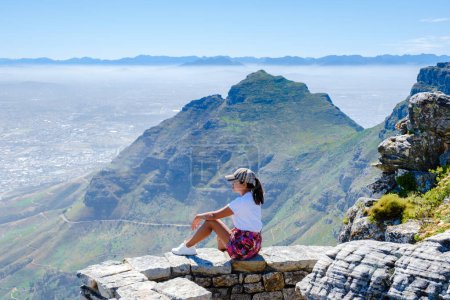 Photo for View from the Table Mountain in Cape Town South Africa, view over the ocean, and Lions Head from Table Mountain Cape Town, Asian women hiking in the mountains of Cape Town South Africa - Royalty Free Image