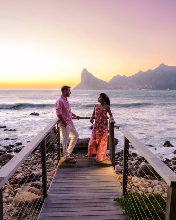 Photo for Couple man and women watching sunset on the balcony at vacation in Cape Town South Africa. - Royalty Free Image