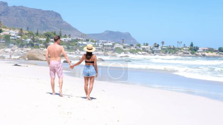 Photo for Couple of men and women at the beach of Camps Bay Cape Town , Camps Bay beach drone aerial view during summer in Cape Town Sout Africa, drone view at the beach during summer - Royalty Free Image