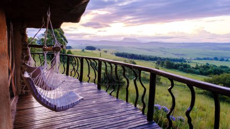 Photo for Drakensberg Giant Castle South Africa, Lodge in the mountains, Drakensberg mountain, Central Drakensberg Kwazulu Natal, Cabin terrace with a view over green mountains in South Africa - Royalty Free Image