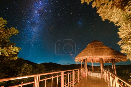 Photo for Luxury safari, South Africa, a luxury safari lodge in the bush of a Game reserve at night with stars milky way in the sky at night - Royalty Free Image
